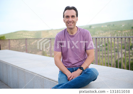 Casual Man Standing Outdoors Near Stairs and Greenery for Everyday Fashion and Lifestyle Photo Casual Man Standing Outdoors Near Stairs and Greenery for Everyday Fashion and Lifestyle Photo 131811038