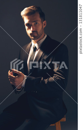 Gentleman, fashion and portrait of a man in suit with style for business looking serious in a studio black background. Confident, proud and handsome male model sitting on a chair adjusting sleeves Gentleman, fashion and portrait of a man in suit with style for business looking serious in a studio black background. Confident, proud and handsome male model sitting on a chair adjusting sleeves 131811047