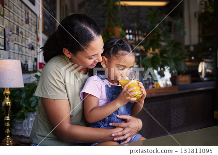 Coffee shop, black family and hug with a mother and daughter enjoying a beverage in a cafe together. Hugging, caffeine and love with a young woman and happy female child bonding in a restaurant Coffee shop, black family and hug with a mother and daughter enjoying a beverage in a cafe together. Hugging, caffeine and love with a young woman and happy female child bonding in a restaurant 131811095