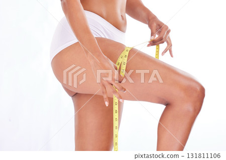 Measuring tape, body and woman for weight loss measure leg for wellness, fitness and health isolated in studio white background. Closeup, exercise and workout results for healthy model Measuring tape, body and woman for weight loss measure leg for wellness, fitness and health isolated in studio white background. Closeup, exercise and workout results for healthy model 131811106