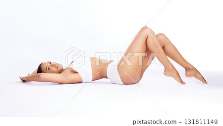 Body, confidence and portrait of a woman in underwear isolated on white background in a studio. Sexy, happy and model lying in a bikini to show legs, lingerie and care for skin on a backdrop Body, confidence and portrait of a woman in underwear isolated on white background in a studio. Sexy, happy and model lying in a bikini to show legs, lingerie and care for skin on a backdrop 131811149
