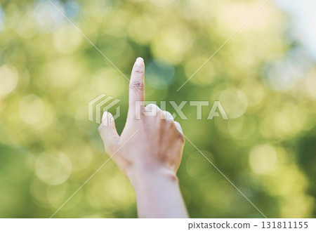 Hand, index finger and pointing in nature, outdoors or at park at something. Direction, bokeh and hands point up for gesture, signal or sign language, counting fingers or emoji, mathematics or timer. 131811155