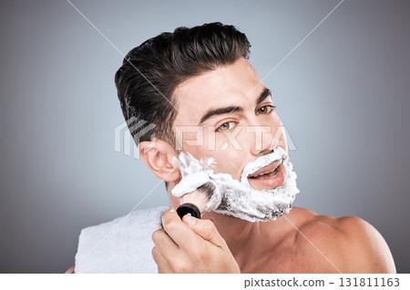 Shaving cream, face and man with brush in studio isolated on a gray background for hair removal. Beard care portrait, grooming and male model with facial product, foam or gel to shave for wellness. Shaving cream, face and man with brush in studio isolated on a gray background for hair removal. Beard care portrait, grooming and male model with facial product, foam or gel to shave for wellness. 131811163