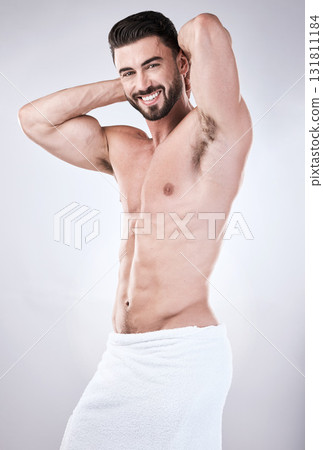 Muscular man, portrait smile and towel flexing for clean hygiene, wash or skincare isolated on gray studio background. Happy attractive male model smiling for fit body, cosmetics or fresh grooming Muscular man, portrait smile and towel flexing for clean hygiene, wash or skincare isolated on gray studio background. Happy attractive male model smiling for fit body, cosmetics or fresh grooming 131811184