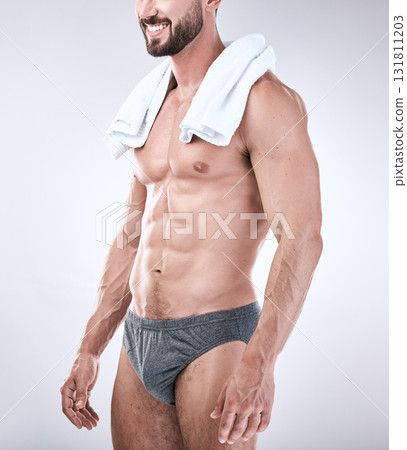 Sexy, underwear and man with muscle as beauty, skincare or self care isolated in studio gray background. Model, handsome and perfect athletic body of masculine male is confident with a towel 131811203