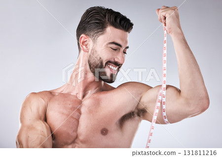 Fitness, body and strong man with tape measure for biceps for exercise goals on studio background. Happy bodybuilder measuring arm for training, workout or muscle growth progress, results or target Fitness, body and strong man with tape measure for biceps for exercise goals on studio background. Happy bodybuilder measuring arm for training, workout or muscle growth progress, results or target 131811216