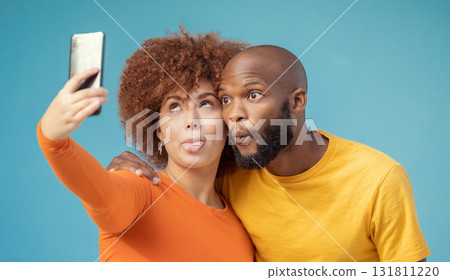 Couple, hug and funny faces selfie on blue background, isolated mockup or wall mock up for social media. Comic, goofy and silly black man and woman on photography tech for interracial profile picture Couple, hug and funny faces selfie on blue background, isolated mockup or wall mock up for social media. Comic, goofy and silly black man and woman on photography tech for interracial profile picture 131811220