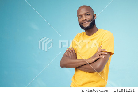 Black man, portrait smile and arms crossed on mockup for advertising or marketing casual fashion. Happy African American male standing in confidence smiling for profile on a blue studio background Black man, portrait smile and arms crossed on mockup for advertising or marketing casual fashion. Happy African American male standing in confidence smiling for profile on a blue studio background 131811231