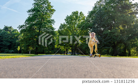 Girl on scooter. Riding child outdoor fun. Sunshine road freedom lifestyle. Girl on scooter. Riding child outdoor fun. Sunshine road freedom lifestyle. 131811256