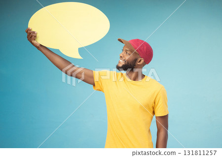 Speech bubble, advertising and black man on blue background for announcement, news and information. Marketing, opinion mockup and male smile with copy space on poster, billboard and sign for voice Speech bubble, advertising and black man on blue background for announcement, news and information. Marketing, opinion mockup and male smile with copy space on poster, billboard and sign for voice 131811257