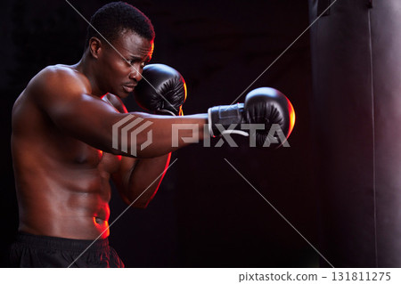 Boxer, fitness and black man isolated on a dark background or gym training focus, challenge and bodybuilder fist impact. Strong, power and boxing athlete or sports person with exercise in mma gear Boxer, fitness and black man isolated on a dark background or gym training focus, challenge and bodybuilder fist impact. Strong, power and boxing athlete or sports person with exercise in mma gear 131811275