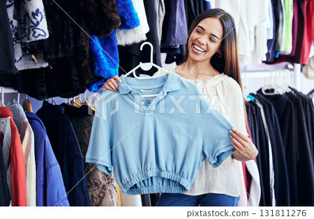 Fashion, shopping or clothes with a black woman customer in a store for retail to buy a contemporary shirt. Sale, style and smile with a female consumer or shopper buying clothing in a boutique Fashion, shopping or clothes with a black woman customer in a store for retail to buy a contemporary shirt. Sale, style and smile with a female consumer or shopper buying clothing in a boutique 131811276