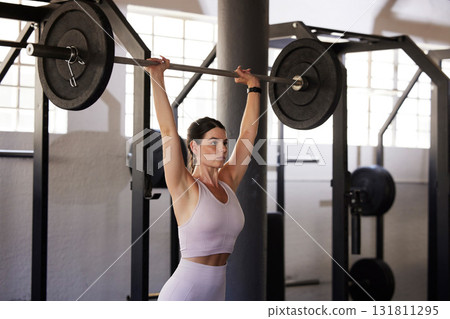Barbell press, woman and exercise for fitness, workout and sports training in gym. Athlete, bodybuilder and overhead weightlifting for wellness, power and energy with motivation, performance or focus Barbell press, woman and exercise for fitness, workout and sports training in gym. Athlete, bodybuilder and overhead weightlifting for wellness, power and energy with motivation, performance or focus 131811295