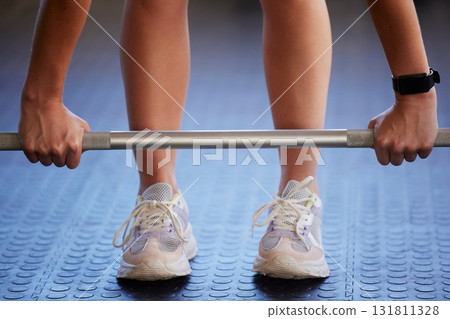 Barbell, hands and woman exercise on floor for fitness, workout and sports challenge in gym. Closeup female athlete, bodybuilder and heavy weights on ground for deadlift, wellness and muscle power 131811328