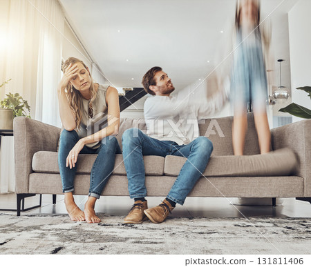 Family life stress, parents and child, chaos at home and energy, motion blur and burnout headache. Kid jump on couch, woman has migraine and man calming girl, hyperactive with ADHD and mental health 131811406