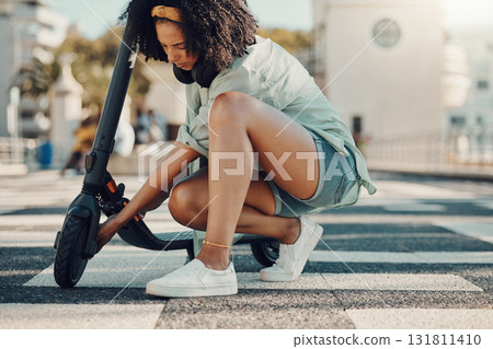 Black woman, scooter and eco friendly travel in city, adventure and fixing the wheel of ebike outdoor. Sustainable transportation, freedom with carbon footprint and transport in urban street in Miami Black woman, scooter and eco friendly travel in city, adventure and fixing the wheel of ebike outdoor. Sustainable transportation, freedom with carbon footprint and transport in urban street in Miami 131811410