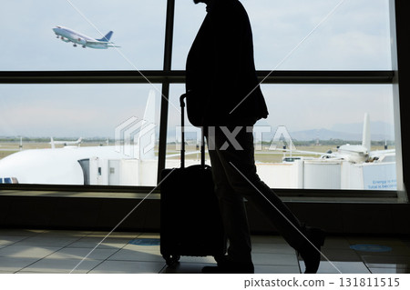 Airport, travel and silhouette person walking to airplane, flight booking or transportation for world trip. Suitcase luggage, plane departure and profile man on holiday, vacation or business journey Airport, travel and silhouette person walking to airplane, flight booking or transportation for world trip. Suitcase luggage, plane departure and profile man on holiday, vacation or business journey 131811515