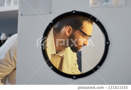 Scientist, man with incubator and science experiment with medical research, biotechnology or ivf with innovation. Scientific study in laboratory, test sample storage and doctor face with researcher 131811535