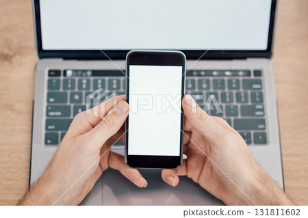 Hands, phone and laptop on mockup screen for networking, social media or mobile app at office desk. Hand of person with display on smartphone for online advertising, branding logo or marketing Hands, phone and laptop on mockup screen for networking, social media or mobile app at office desk. Hand of person with display on smartphone for online advertising, branding logo or marketing 131811602