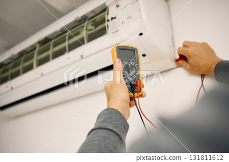 Air conditioner, maintenance hands and voltage meter with construction, wall and technician man. AC repair, professional hvac expert and handyman with digital reading, analysis or engineering service Air conditioner, maintenance hands and voltage meter with construction, wall and technician man. AC repair, professional hvac expert and handyman with digital reading, analysis or engineering service 131811612