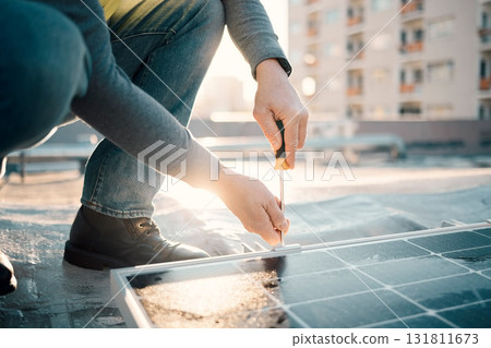 Solar panel, screwdriver and worker hands with tools for renewable energy and electricity. Sustainable innovation, roof work and engineering employ install eco friendly and sustainability product 131811673