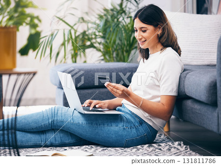 Credit card, online shopping and woman on laptop, banking and fintech for easy payment on home carpet. Young person or student with computer for e commerce sale, finance and wealth in her living room Credit card, online shopping and woman on laptop, banking and fintech for easy payment on home carpet. Young person or student with computer for e commerce sale, finance and wealth in her living room 131811786