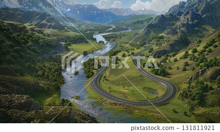 Serpentine road winds through lush green mountain valley beside flowing river and distant snow capped peaks Serpentine road winds through lush green mountain valley beside flowing river and distant snow capped peaks 131811921