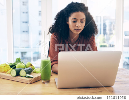 Relax, smoothie and health with black woman and laptop for blog research, salad and vegetables. Nutritionist, diet and food with girl by kitchen counter for cooking, technology and learning at home Relax, smoothie and health with black woman and laptop for blog research, salad and vegetables. Nutritionist, diet and food with girl by kitchen counter for cooking, technology and learning at home 131811958