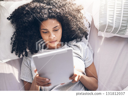 Black woman, tablet and top view in bed in bedroom for social media, texting or internet browsing in the morning. Technology, relax and female on digital touchscreen for web scrolling or networking. 131812037