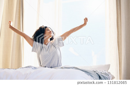 Black woman, morning stretching and wake up in home bedroom after sleeping or resting. Relax, peace and comfort of young female stretch after sleep feeling fresh, awake and well rested in house. Black woman, morning stretching and wake up in home bedroom after sleeping or resting. Relax, peace and comfort of young female stretch after sleep feeling fresh, awake and well rested in house. 131812085