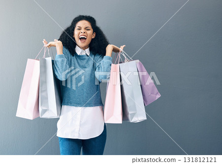 Shopping, black woman excited and scream portrait of a happy customer with bags after shop sale. Isolated, gray background and female smile in a studio holding a bag with discount market product Shopping, black woman excited and scream portrait of a happy customer with bags after shop sale. Isolated, gray background and female smile in a studio holding a bag with discount market product 131812121