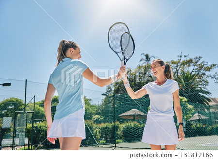 Tennis, racket high five and women teamwork for sport game outdoor for exercise and fitness. Sports achievement, winner and happy athlete partner team feeling success from workout goals on court Tennis, racket high five and women teamwork for sport game outdoor for exercise and fitness. Sports achievement, winner and happy athlete partner team feeling success from workout goals on court 131812166