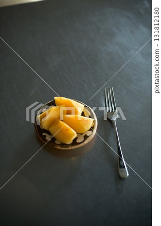 Cut persimmons arranged in a small bowl 131812180