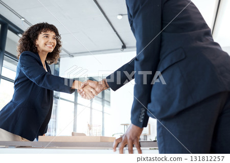 Business people, handshake and smile for b2b, meeting or partnership in teamwork at the office. Happy female executive shaking hands with employee for interview, greeting or introduction at workplace 131812257