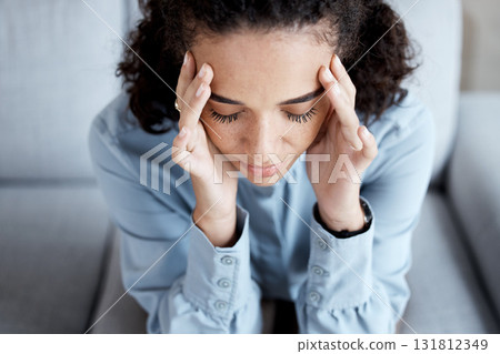 Stress, headache and woman at psychology for mental health, grief or depression counseling. Frustration, anxiety and sad stressed female patient sitting on sofa with migraine at psychotherapy session 131812349