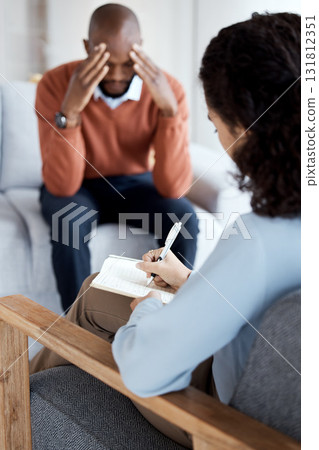 Woman psychologist writing, black man in therapy with mental health, stress headache and depressed with help. Consultation, doctor report on patient diagnosis, anxiety problem and sad with depression 131812351