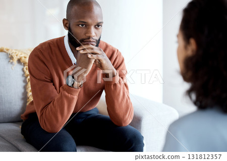 Mental health, depression and black man with a therapist for grief, depression or anxiety counseling. Psychology, sad and professional psychologist helping a African male patient in a clinic session. 131812357