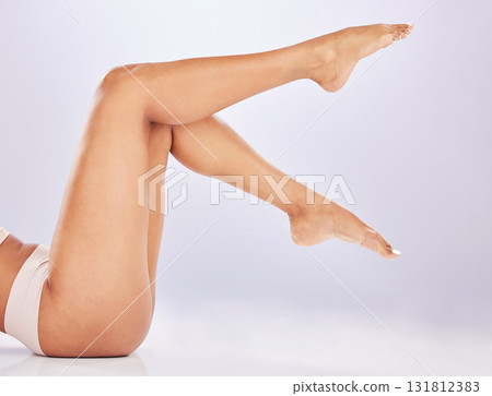 Skincare, glow and legs of a smooth woman isolated on a white background in a studio. Spa, grooming and feet and body of a girl glowing from a treatment, wellness and care for skin on a backdrop 131812383