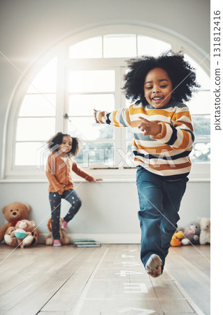 Hopscotch, happy and children play in home having fun, enjoy games and relax together in room. Childhood, entertainment and excited siblings in bedroom for jumping game, playing and activity Hopscotch, happy and children play in home having fun, enjoy games and relax together in room. Childhood, entertainment and excited siblings in bedroom for jumping game, playing and activity 131812416