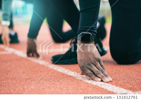 Athlete, runner and fitness person at start of a race on a sports track for exercise, workout or motivation. Running, sprint and closeup of man ready for training as wellness, competition and health Athlete, runner and fitness person at start of a race on a sports track for exercise, workout or motivation. Running, sprint and closeup of man ready for training as wellness, competition and health 131812701