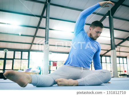 Sports, gymnastics and man stretching body ready to start warm up for training, exercise and workout on floor. Fitness, motivation and male athlete with focus for balance, performance and competition Sports, gymnastics and man stretching body ready to start warm up for training, exercise and workout on floor. Fitness, motivation and male athlete with focus for balance, performance and competition 131812710