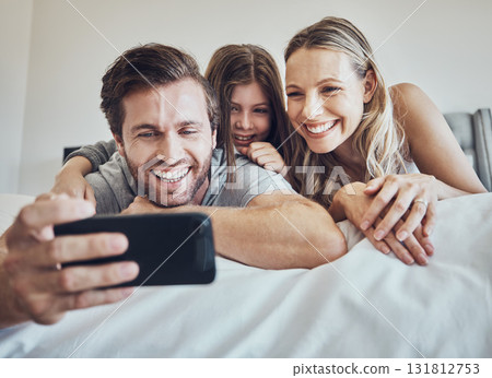 Portrait, relax or parents take a selfie with a girl as a happy family in house bedroom bonding in Berlin. Mother, father or child relaxing together enjoying quality time or taking pictures at home Portrait, relax or parents take a selfie with a girl as a happy family in house bedroom bonding in Berlin. Mother, father or child relaxing together enjoying quality time or taking pictures at home 131812753