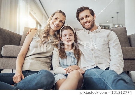 Portrait, mother or father with a kid to relax as a happy family in living room bonding in Australia with love or care. Hugging, trust or parent smile with girl enjoying quality time on a fun holiday Portrait, mother or father with a kid to relax as a happy family in living room bonding in Australia with love or care. Hugging, trust or parent smile with girl enjoying quality time on a fun holiday 131812774