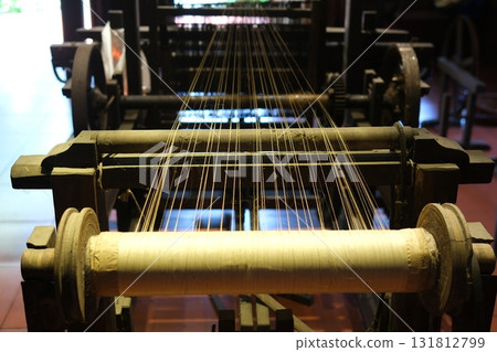 Separate silk worm via spinning wheel, Thai wisdom. process highlights sustainable textile making, natural materials, and the dedication in rural workshops. 131812799