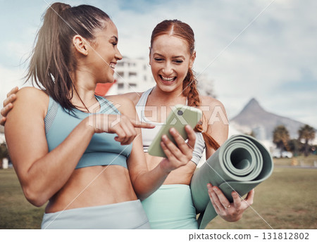 Yoga, fitness and social media with woman friends in the park together for mental health exercise. Exercise, phone and training with a female and friend outside on a grass field for a summer workout 131812802