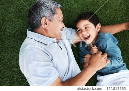 Grandfather, child and laughing on grass having fun with love and grandparent care. Laugh, happy kid from above and senior man together outdoor on summer vacation with family and bonding in nature Grandfather, child and laughing on grass having fun with love and grandparent care. Laugh, happy kid from above and senior man together outdoor on summer vacation with family and bonding in nature 131812863