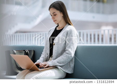 Research, library or woman student on laptop for internet, communication or blog news in college lobby. Typing, digital or girl sitting on tech for networking, website search or online content review Research, library or woman student on laptop for internet, communication or blog news in college lobby. Typing, digital or girl sitting on tech for networking, website search or online content review 131812894