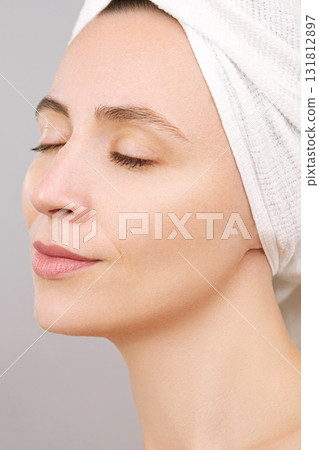 Closed eyes. Calm face. Beautiful female model with perfect clean skin. Concept of a skincare, cosmetics ad. Isolated studio grey background. Plastic surgery, beauty salon. Self care. Laser treatment Closed eyes. Calm face. Beautiful female model with perfect clean skin. Concept of a skincare, cosmetics ad. Isolated studio grey background. Plastic surgery, beauty salon. Self care. Laser treatment 131812897
