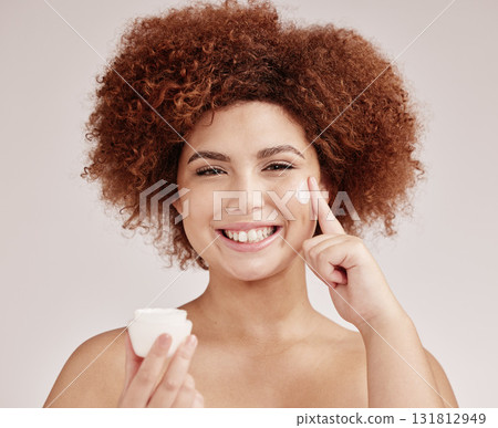 Skincare, product and portrait of black woman with cream on face, smile and advertising luxury skin promotion. Dermatology, cosmetics and facial for happy model with jar isolated on studio background Skincare, product and portrait of black woman with cream on face, smile and advertising luxury skin promotion. Dermatology, cosmetics and facial for happy model with jar isolated on studio background 131812949
