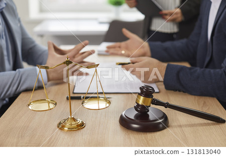 Male lawyer having consultation with a man client on his workplace in office. 131813040